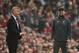 Liverpool's German manager Jurgen Klopp (R) and Manchester United's Norwegian caretaker manager Ole Gunnar Solskjaer (L) gesture to their players during the English Premier League football match between Manchester United and Liverpool at Old Trafford in