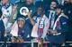 PARIS, FRANCE - MAY 18: Presnel Kimpembe, Dani Alves (hidden by the trophy), assistant coach Zoumana Camara, Neymar Jr of PSG celebrate winning the 'French Championship 2018-2019' during the trophy ceremony following the French Ligue 1 match between Paris