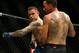 Poirier (left) hits Max Holloway.