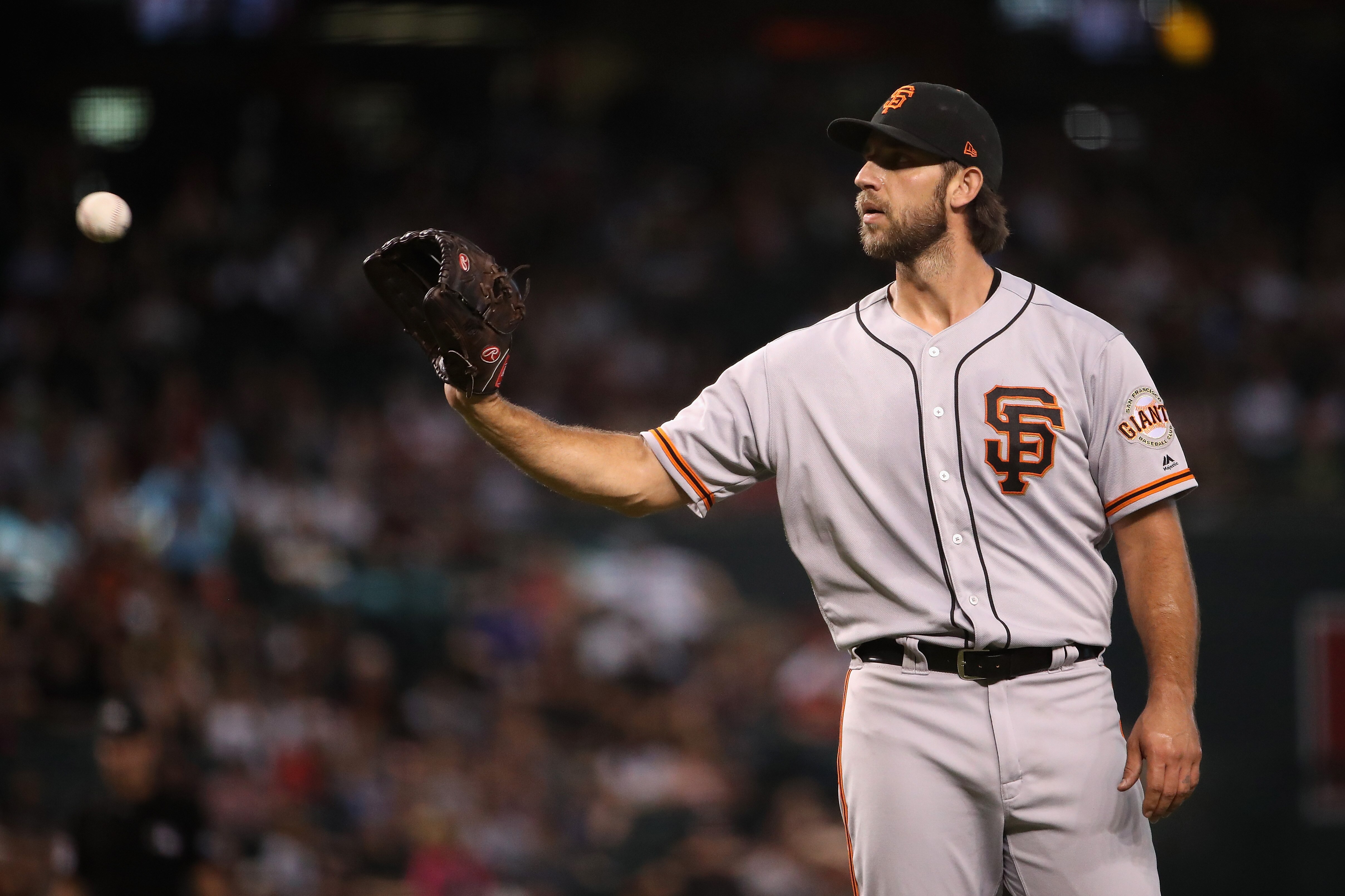 PHOENIX, ARIZONA - AUGUST 18:  Starting pitcher Madison Bumgarner #40 of the San Francisco Giants catches a throw back during the third inning of the MLB game against the Arizona Diamondbacks at Chase Field on August 18, 2019 in Phoenix, Arizona. (Photo b