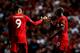 LIVERPOOL, ENGLAND - SEPTEMBER 14: Sadio Mane of Liverpool celebrates with Roberto Firmino after he scores his team's second goal during the Premier League match between Liverpool FC and Newcastle United at Anfield on September 14, 2019 in Liverpool, Unit