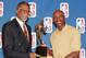 NORTHBROOK, UNITED STATES: Former NBA great Bill Russell (L) hands Michael Jordan (R) of the Chicago Bulls his fifth Maurice Podoloff Most Valuable Player Trophy for the 1997-98 season 18 May, at a press conference at the Sheraton North Shore Hotel in No
