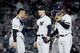 NEW YORK, NEW YORK - OCTOBER 18: Tommy Kahnle #48 of the New York Yankees talks with Gary Sanchez #24 and Didi Gregorius #18 against the Houston Astros during the seventh inning in game five of the American League Championship Series at Yankee Stadium on