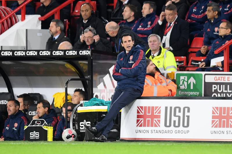 SHEFFIELD, ENGLAND - OCTOBER 21:   Unai Emery, Manager of Arsenal sits on an advertising board on the sideline during the Premier League match between Sheffield United and Arsenal FC at Bramall Lane on October 21, 2019 in Sheffield, United Kingdom. (Photo