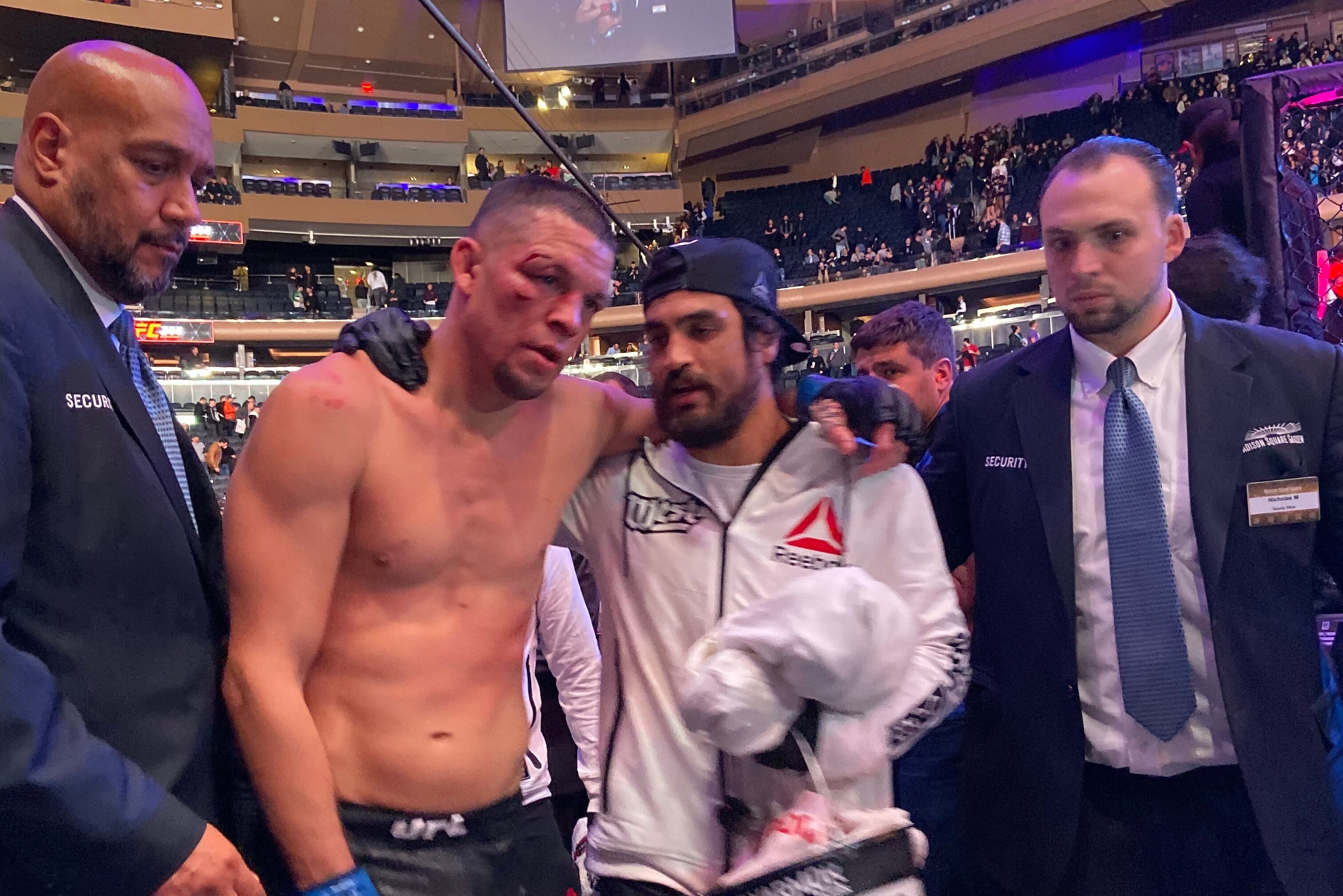 Diaz walks past press row after the fight with corner man Kron Gracie