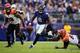 BALTIMORE, MD - OCTOBER 13: Lamar Jackson #8 of the Baltimore Ravens scrambles to avoid the diving tackle attempt of Geno Atkins #97 of the Cincinnati Bengals during the second half at M&T Bank Stadium on October 13, 2019 in Baltimore, Maryland. (Photo by
