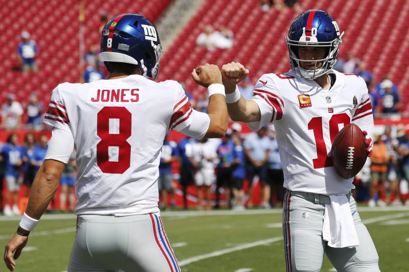 TAMPA, FLORIDA - SEPTEMBER 22: Quarterbacks Daniel Jones #8 and Eli Manning #10 of the New York Giants fist bump during warmups before the game against the Tampa Bay Buccaneers at Raymond James Stadium on September 22, 2019 in Tampa, Florida. (Photo by Mi