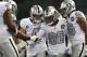 OAKLAND, CALIFORNIA - NOVEMBER 07: Josh Jacobs #28 of the Oakland Raiders is congratulated by teammates including Derek Carr #4 after he ran the ball in for the winning touchdown against the Los Angeles Chargers in the fourth quarter at RingCentral Coli