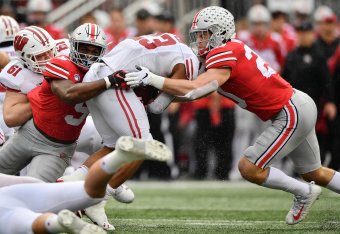 COLUMBUS, OH - OCTOBER 26: Baron Browning #5 of the Ohio State Buckeyes and Pete Werner #20 of the Ohio State Buckeyes tackle Jonathan Taylor #23 of the Wisconsin Badgers at Ohio Stadium on October 26, 2019 in Columbus, Ohio. (Photo by Jamie Sabau/Getty