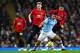 MANCHESTER, ENGLAND - DECEMBER 07: Rodrigo of Manchester City and Jesse Lingard and Scott Mctominay of Manchester United in action during the Premier League match between Manchester City and Manchester United at Etihad Stadium on December 07, 2019 in Ma
