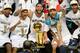 The San Antonio Spurs celebrate with the Larry O'Brien NBA Championship Trophy after the Spurs defeated the Miami Heat 107-84 in Game 5 of the NBA Finals to win the NBA Finals Championship, June 15, 2014 in San Antonio,Texas. From left are: MVP Kawhi Leo