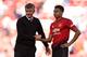 Manchester United's English midfielder Jesse Lingard (R) shakes hands with Manchester United's Norwegian manager Ole Gunnar Solskjaer (L) on the pitch after the English Premier League football match between Manchester United and Cardiff City at Old Traff