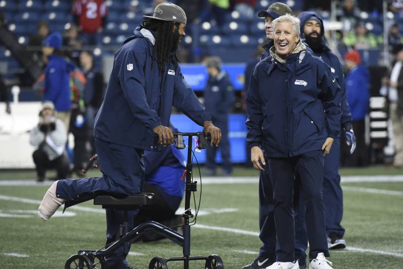 SEATTLE, WA - NOVEMBER 20: Cornerback Richard Sherman #25 of the Seattle Seahawks, out for the season with an Achilles injury, talks with Head coach Pete Carroll before the game at CenturyLink Field on November 20, 2017 in Seattle, Washington. (Photo by