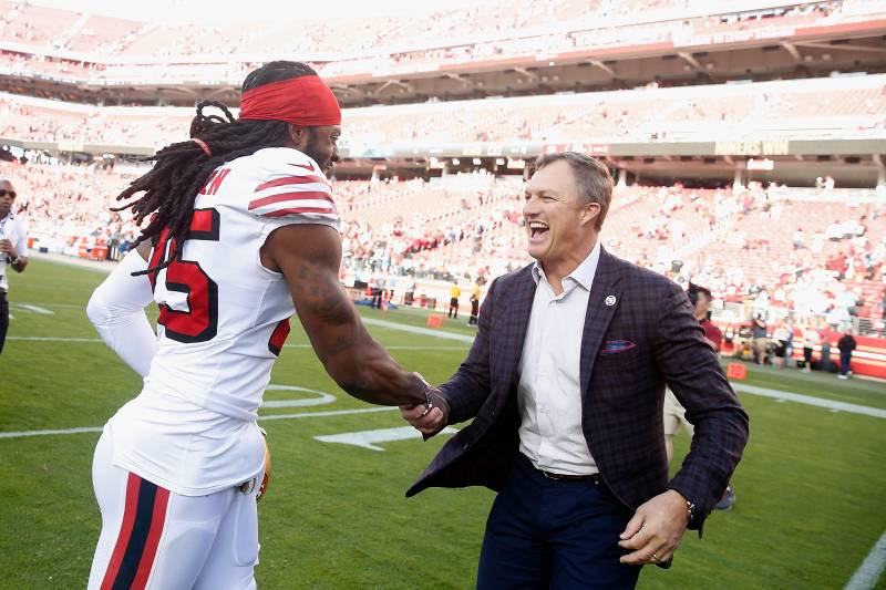 SANTA CLARA, CALIFORNIA - OCTOBER 27: San Francisco 49ers General Manager John Lynch congratulates Richard Sherman #25 after a win against the Carolina Panthers at Levi's Stadium on October 27, 2019 in Santa Clara, California. (Photo by Lachlan Cunningham
