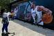 LOS ANGELES, CA - JULY 24: A fan has her picture taken in front of the mural after it was unveiled following the introductory news conference of Kawhi Leonard and Paul George at Green Meadows Recreation Center on July 24, 2019 in Los Angeles, California.