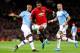 MANCHESTER, ENGLAND - JANUARY 07: Marcus Rashford of Manchester United is challenged by Fernandinho of Manchester City during the Carabao Cup Semi Final match between Manchester United and Manchester City at Old Trafford on January 07, 2020 in Manchester,