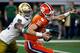ARLINGTON, TEXAS - DECEMBER 29: Trevor Lawrence #16 of the Clemson Tigers scrambles away from Julian Okwara #42 of the Notre Dame Fighting Irish in the first quarter during the College Football Playoff Semifinal Goodyear Cotton Bowl Classic at AT&T Stadiu