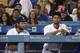 LOS ANGELES, CA - AUGUST 11: (L-R) Alex Wood #57, Clayton Kershaw #22 and Yu Darvish #21 of the Los Angeles Dodgers look on from the dugout with the Dodgers down 4-3 to the San Diego Padres during the ninth inning of their MLB game at Dodger Stadium on A