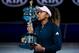 MELBOURNE, AUSTRALIA - JANUARY 26: Naomi Osaka of Japan celebrates with the trophy after beating Petra Kvitova of the Czech Republic in the women's final during day 13 of the 2019 Australian Open at Melbourne Park on January 26, 2019 in Melbourne, Austral
