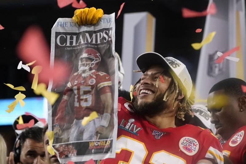 TOPSHOT - Strong safety for the Kansas City Chiefs Tyrann Mathieu and teammates celebrate on the podium after winning Super Bowl LIV against the San Francisco 49ers at Hard Rock Stadium in Miami Gardens, Florida, on February 2, 2020. (Photo by TIMOTHY A. 