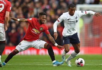 TOPSHOT - Manchester United's Brazilian midfielder Fred (L) vies with Liverpool's Dutch midfielder Georginio Wijnaldum (R) during the English Premier League football match between Manchester United and Liverpool at Old Trafford in Manchester, north west E