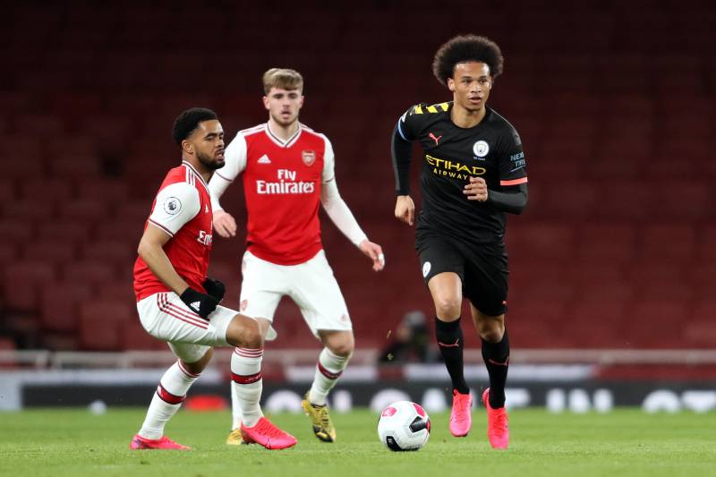 LONDON, ENGLAND - FEBRUARY 28: Leroy Sane of Manchester City runs with the ball under pressure from Trae Coyle of Arsenal during the Premier League 2 match between Arsenal U23 and Manchester City U23 at Emirates Stadium on February 28, 2020 in London, Eng