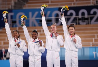 TOKYO, JAPAN - JULY 27: Jordan Chiles, Simone Biles, Grace McCallum and Sunisa Lee of Team United States react on the podium after winning the silver medal during the Women's Team Final on day four of the Tokyo 2020 Olympic Games at Ariake Gymnastics Cent