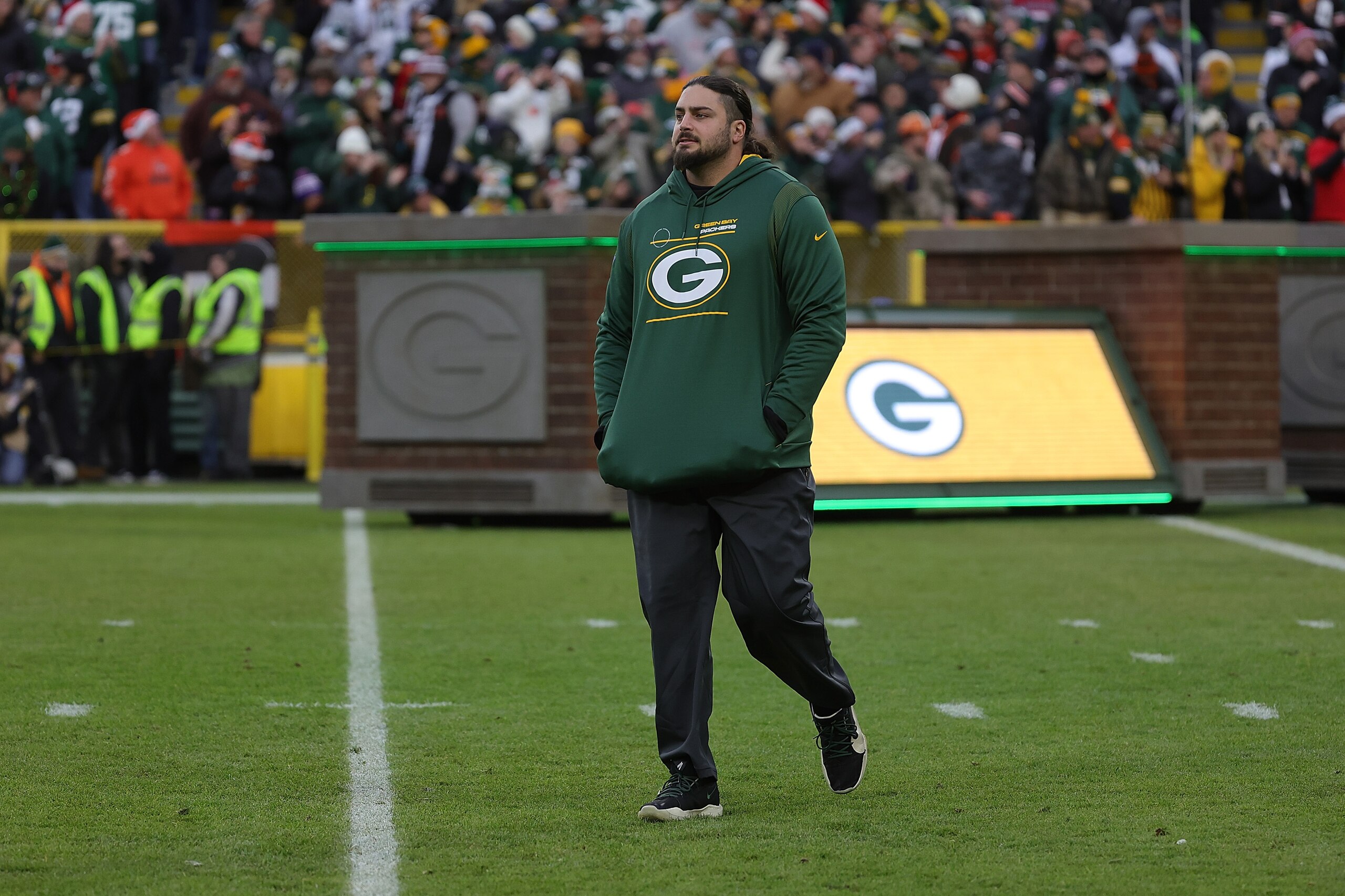 GREEN BAY, WISCONSIN - DECEMBER 25: David Bakhtiari #69 of the Green Bay Packers walks out duri player introductions prior to a game against the Cleveland Browns at Lambeau Field on December 25, 2021 in Green Bay, Wisconsin.  The Packers defeated the Brow