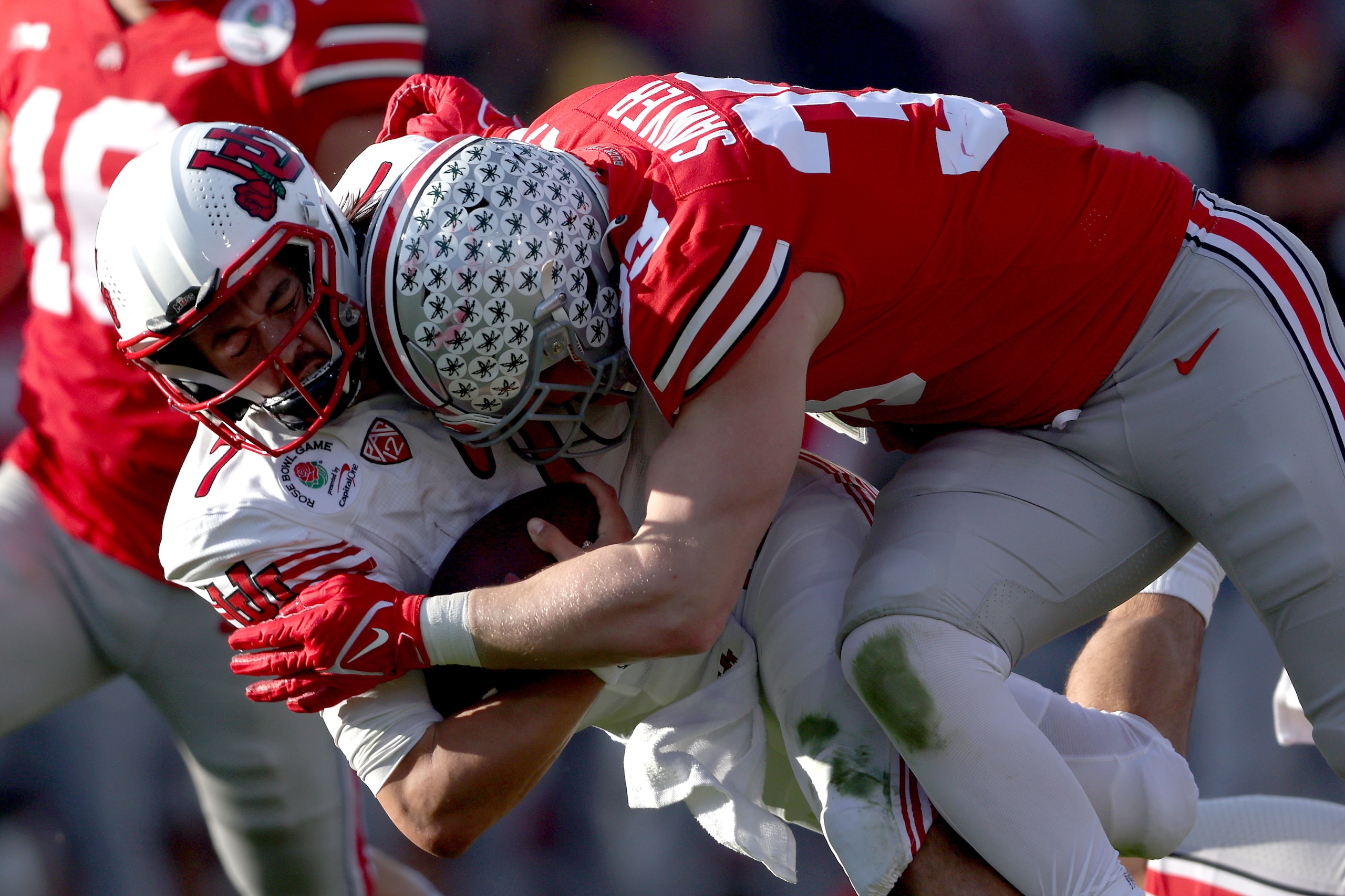 PASADENA, CALIFORNIA - JANUARY 01: Jack Sawyer #33 of the Ohio State Buckeyes is called for targeting after this hit onCameron Rising #7 of the Utah Utes during the first half in the Rose Bowl Game at Rose Bowl Stadium on January 01, 2022 in Pasadena, Cal