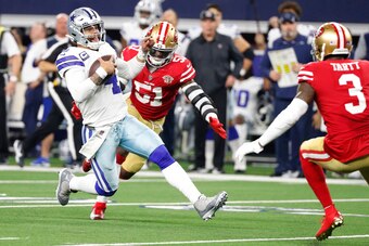 ARLINGTON, TEXAS - JANUARY 16: Dak Prescott #4 of the Dallas Cowboys scrambles with the ball on the last play of the game against the San Francisco 49ers during the fourth quarter in the NFC Wild Card Playoff game at AT&T Stadium on January 16, 2022 in Ar