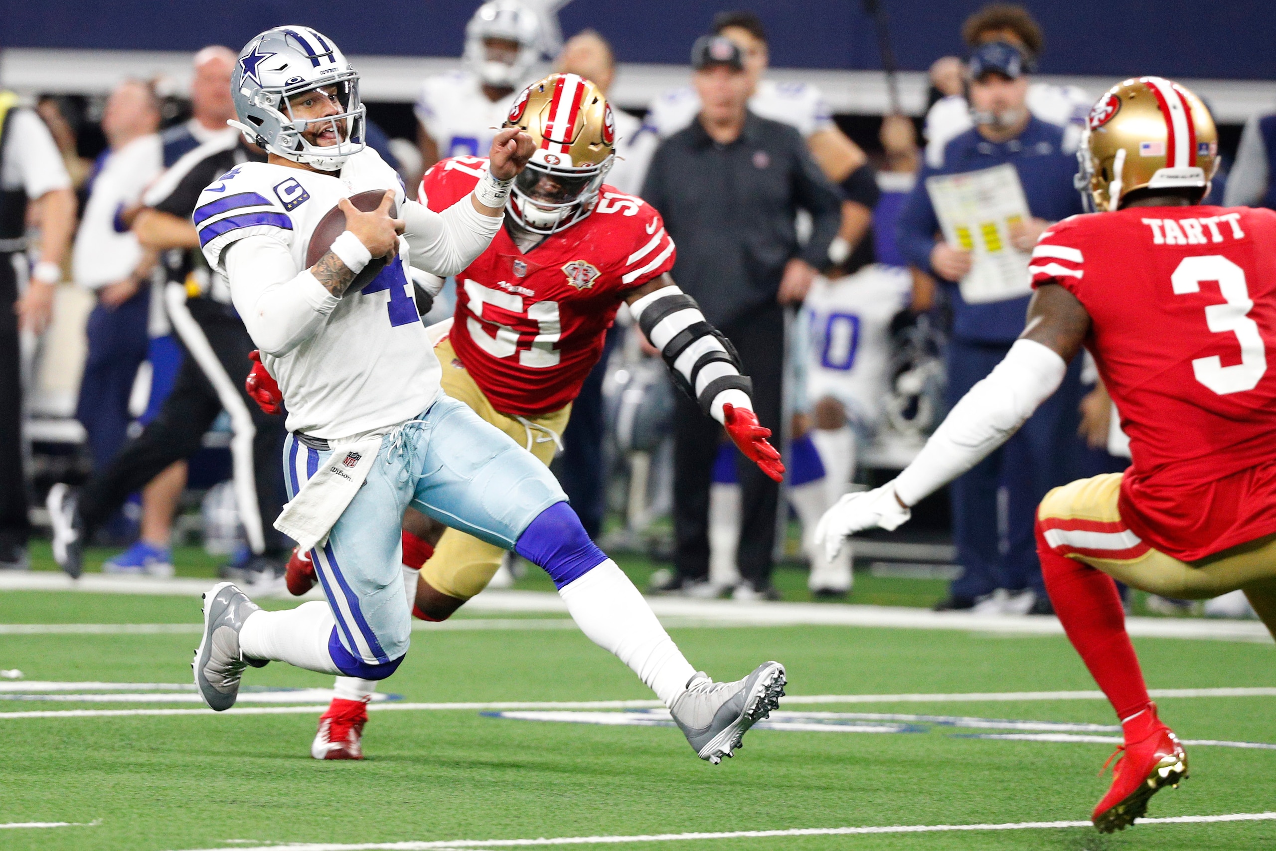 ARLINGTON, TEXAS - JANUARY 16: Dak Prescott #4 of the Dallas Cowboys scrambles with the ball on the last play of the game against the San Francisco 49ers during the fourth quarter in the NFC Wild Card Playoff game at AT&T Stadium on January 16, 2022 in Ar