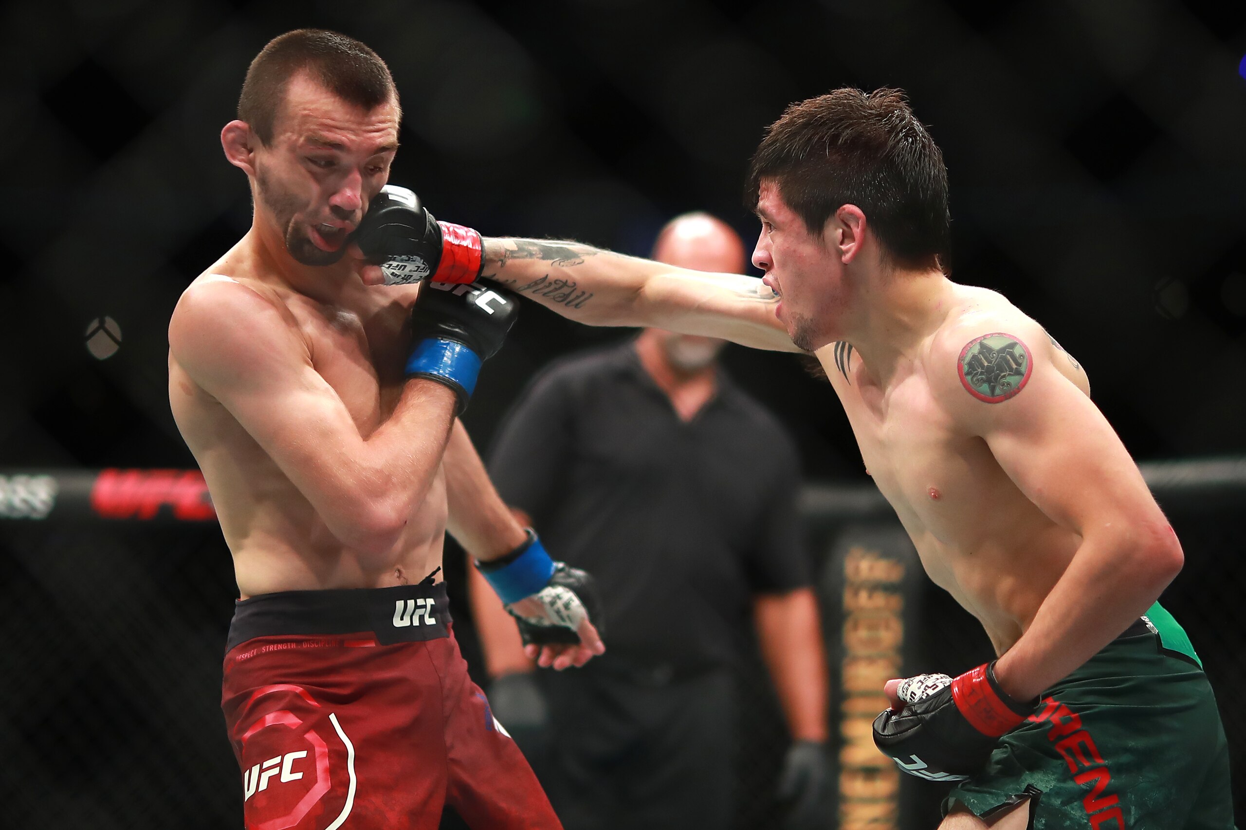 MEXICO CITY, MEXICO - SEPTEMBER 21:  Brandon Moreno of Mexico punches Askar Askarov of Russia in their flyweight bout during UFC Fight Night event at Arena Ciudad de Mexico on September 21, 2019 in Mexico City, Mexico. (Photo by Hector Vivas/Zuffa LLC/Zuf