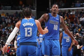 MEMPHIS, TN - JANUARY 14: Dorian Finney-Smith #10 hi-fives Jalen Brunson #13 of the Dallas Mavericks during the game against the Memphis Grizzlies on January 14, 2022 at FedExForum in Memphis, Tennessee. NOTE TO USER: User expressly acknowledges and agree