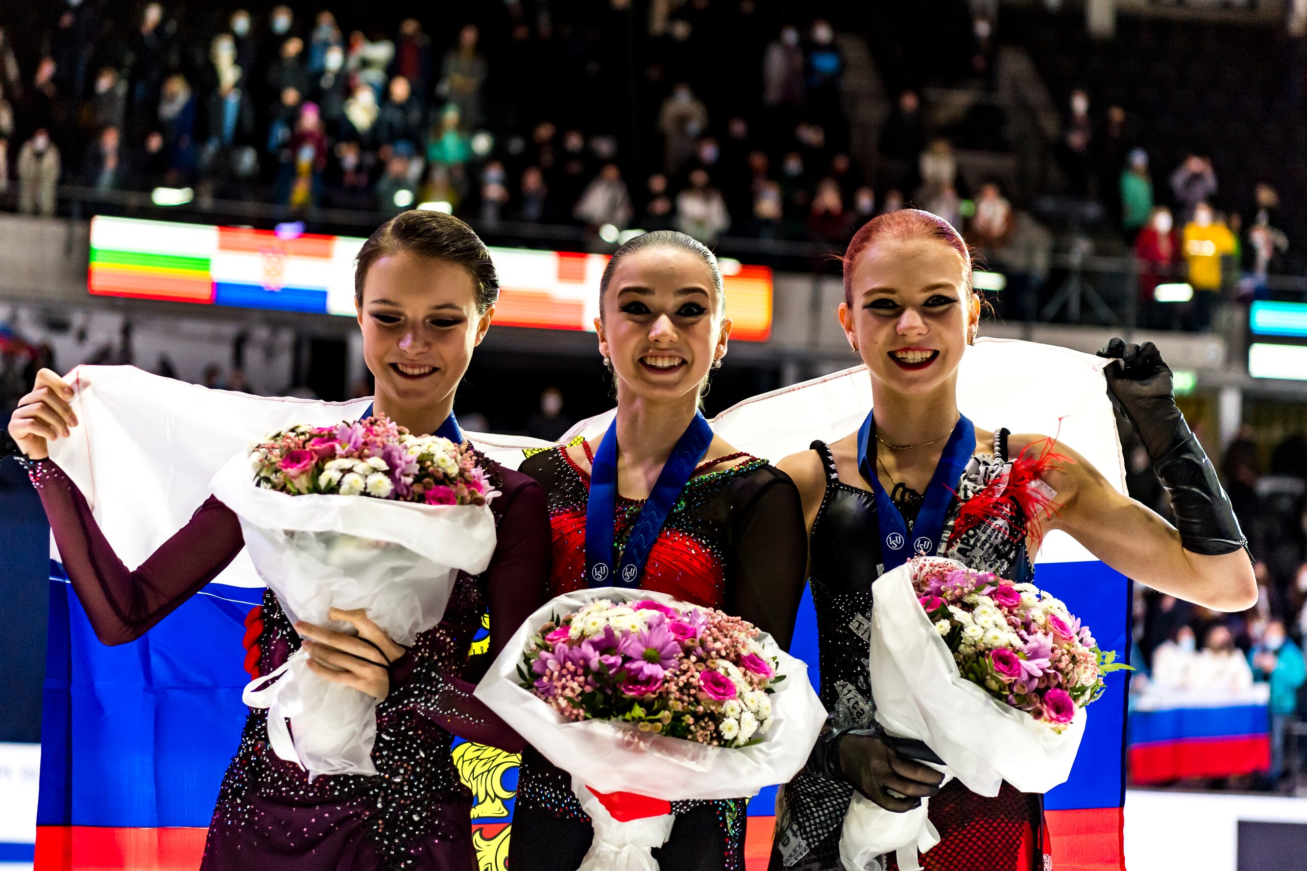 TALLINN, ESTONIA - JANUARY 15: Gold medal winner Kamila Valieva of Russia, silver medal winner Anna Scherbakova of Russia and bronze medal winner Alexandra Trusova of Russia pose with medals during victory ceremony after the ISU European Figure Skating Ch