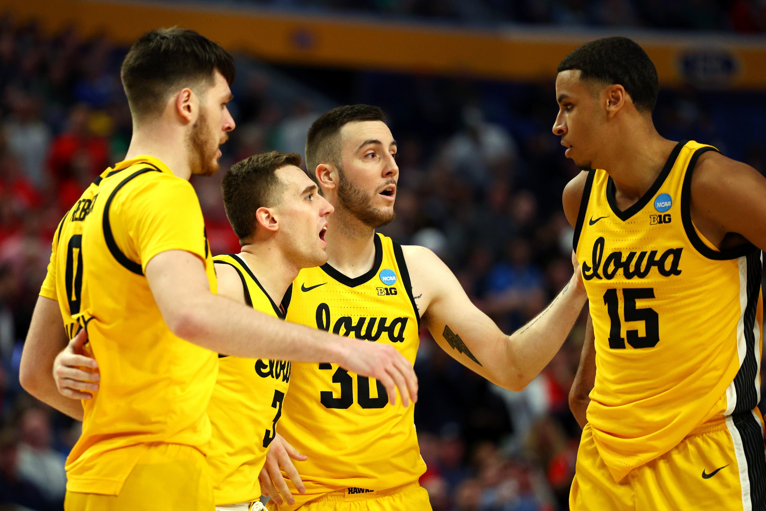 BUFFALO, NEW YORK - MARCH 17: Filip Rebraca #0, Jordan Bohannon #3, Connor McCaffery #30 and Keegan Murray #15 of the Iowa Hawkeyes huddle up during the second half against the Richmond Spiders in the first round game of the 2022 NCAA Men's Basketball Tou