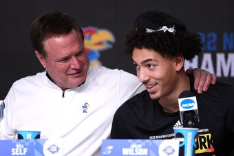 NEW ORLEANS, LOUISIANA - APRIL 04: Head coach Bill Self of the Kansas Jayhawks embraces Jalen Wilson #10 after defeating the North Carolina Tar Heels to win the 2022 NCAA Men's Basketball Tournament National Championship game at Caesars Superdome on April