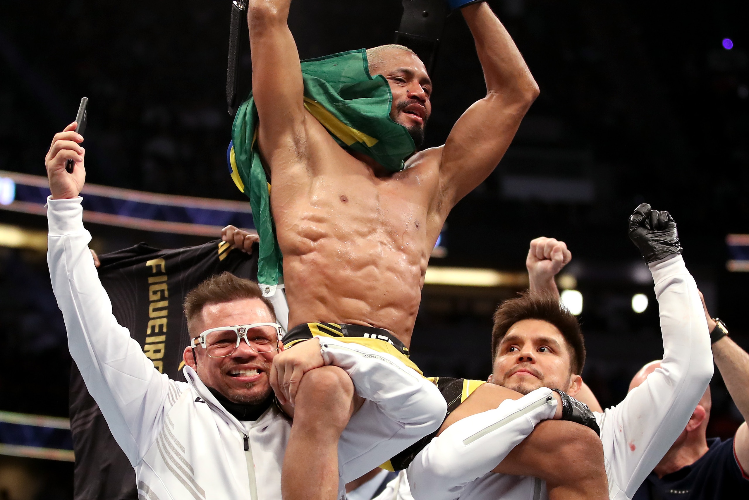 ANAHEIM, CALIFORNIA - JANUARY 22: Deiveson Figueiredo of Brazil celebrates with his team after defeating Brandon Moreno of Mexico after their flyweight title fight during the UFC 270 event at Honda Center on January 22, 2022 in Anaheim, California. (Photo