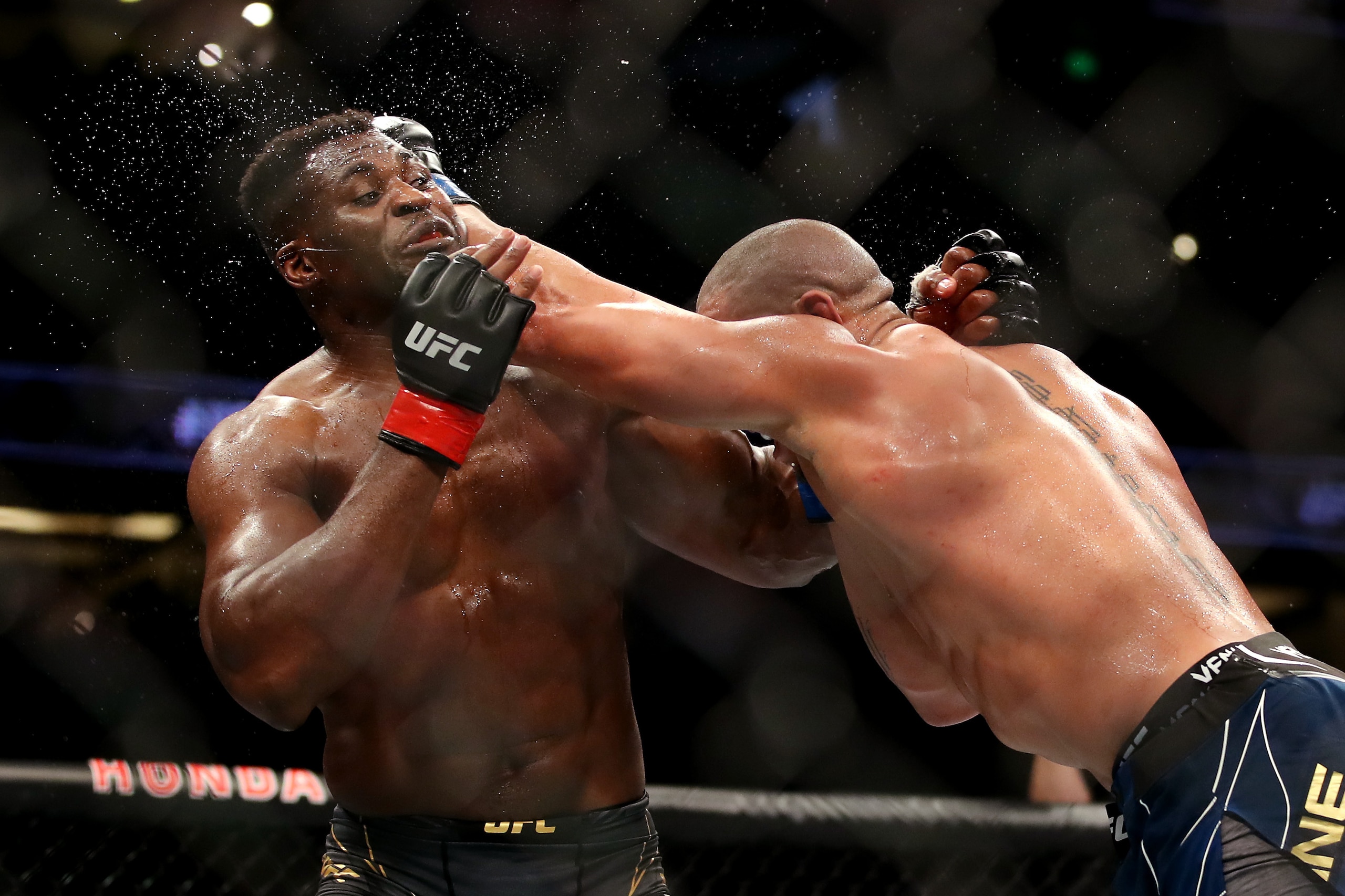 ANAHEIM, CALIFORNIA - JANUARY 22: Ciryl Gane of France (right) punches Francis Ngannou of Cameroon in their heavyweight title fight during the UFC 270 event at Honda Center on January 22, 2022 in Anaheim, California. (Photo by Katelyn Mulcahy/Getty Images