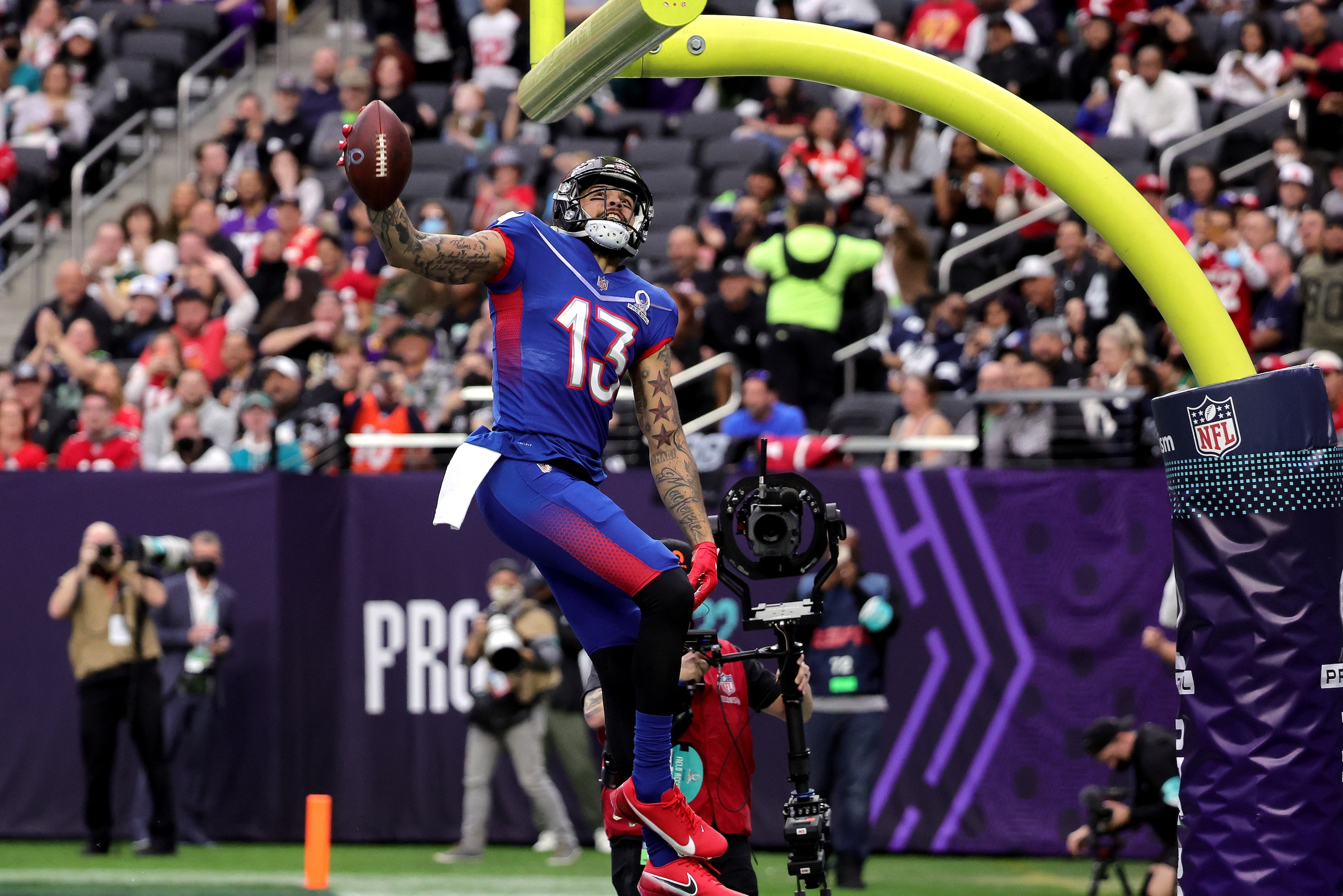 LAS VEGAS, NEVADA - FEBRUARY 06:  Mike Evans #13 of the Tampa Bay Buccaneers and NFC celebrates after scoring a 19-yard touchdown against the AFC with a between-the-legs dunk through the goal post in the first half of the 2022 NFL Pro Bowl at Allegiant St
