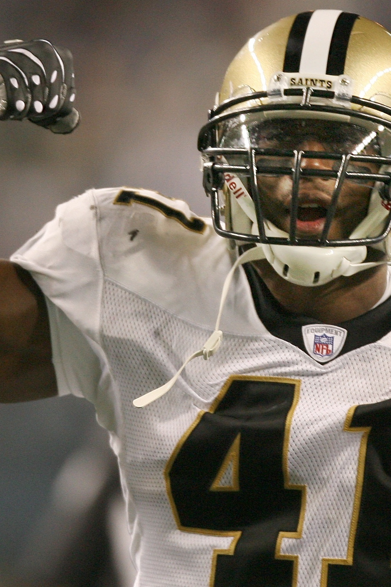 A stunned New Orleans Saints' Roman Harper walks off the field as