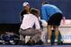 MELBOURNE, AUSTRALIA - JANUARY 19: Andy Roddick of the USA is looked at by medical staff before retiring in his second round match against Lleyton Hewitt of Australia during day four of the 2012 Australian Open at Melbourne Park on January 19, 2012 in Melbourne, Australia. (Photo by Quinn Rooney/Getty Images)
