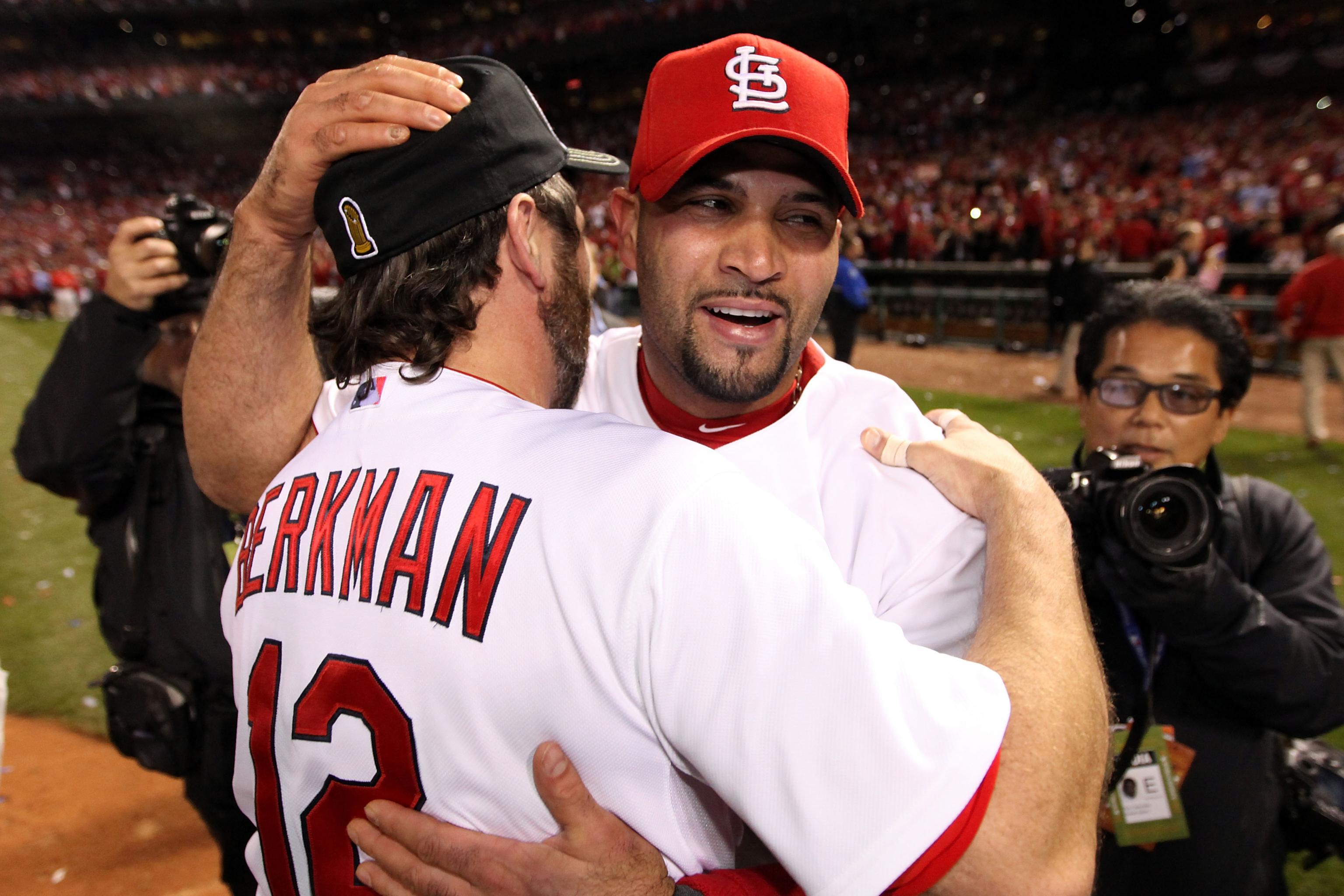 St. Louis Cardinals Lance Berkman embraces Albert Pujols after the  Cardinals won the 2011 World Series in St. Louis on October 28, 2011. The  Cardinals defeated the Texas Rangers 6-2 winning game