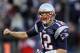FOXBORO, MA - JANUARY 01: Tom Brady #12 of the New England Patriots celebrates a touchdown by teammate BenJarvus Green-Ellis in the fourth quarter against the Buffalo Bills on January 1, 2012 at Gillette Stadium in Foxboro, Massachusetts. (Photo by Elsa/Getty Images)