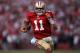 SAN FRANCISCO, CA - JANUARY 14: Alex Smith #11 of the San Francisco 49ers runs in for a touchdown in the fourth quarter against the New Orleans Saints during the NFC Divisional playoff game at Candlestick Park on January 14, 2012 in San Francisco, California. (Photo by Jed Jacobsohn/Getty Images)