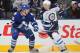 TORONTO, CANADA - JANUARY 05: Eric Fehr #17 of the Winnipeg Jets chips a puck past Carl Gunnarsson #36 of the Toronto Maple Leafs in a game on January 5, 2012 at the Air Canada Centre in Toronto, Canada. The Leafs defeated the Jets 4-0. (Photo by Claus Andersen/Getty Images)