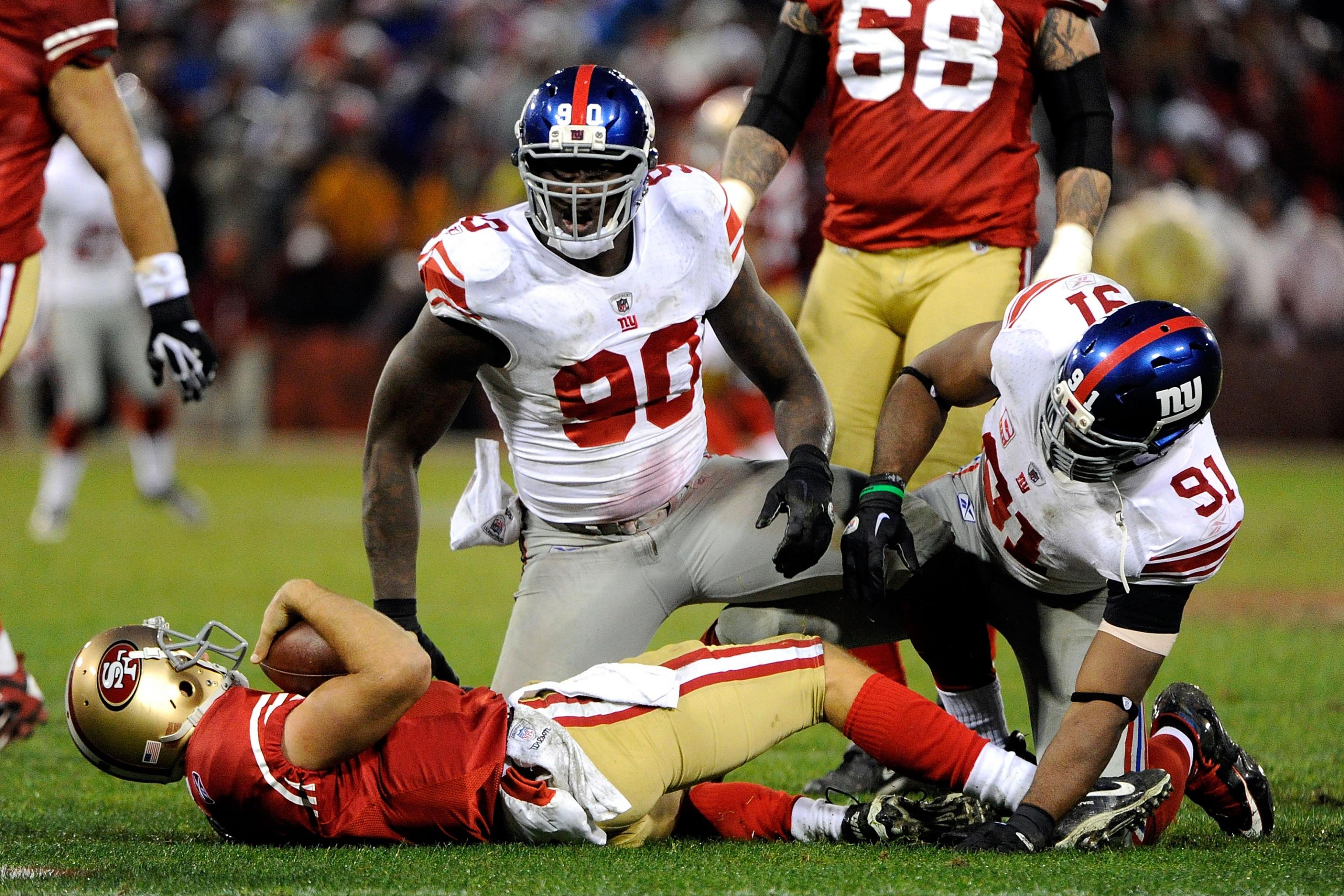 New York Giants Michael Strahan reacts to a sack in week 13 at