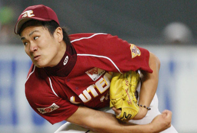 Japanese free agent outfielder Kosuke Fukudome, left, shows his