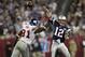GLENDALE, AZ - FEBRUARY 03: Tom Brady #12 of of the New England Patriots passes the ball as his arm is hit by defensive lineman Justin Tuck #91 of the New York Giants in the fourth quarter of Super Bowl XLII on February 3, 2008 at the University of Phoenix Stadium in Glendale, Arizona. (Photo by Elsa/Getty Images)