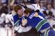 VANCOUVER, CANADA - JANUARY 17: Keith Ballard #4 of the Vancouver Canucks and Colin Fraser #24 of the Los Angeles Kings fight during the second period in NHL action on January 17, 2012 at Rogers Arena in Vancouver, British Columbia, Canada. (Photo by Rich Lam/Getty Images)