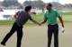 ABU DHABI, UNITED ARAB EMIRATES - JANUARY 26: Rory McIlroy of Northern Ireland and Tiger Woods of the USA shake hands on the 18th green during the first round of Abu Dhabi HSBC Golf Championship at the Abu Dhabi HSBC Golf Championship on January 26, 2012 in Abu Dhabi, United Arab Emirates. (Photo by Ross Kinnaird/Getty Images)
